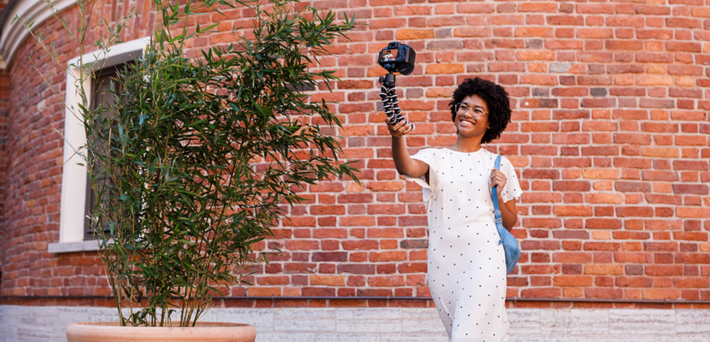 Black woman filming herself for her business's video marketing content.